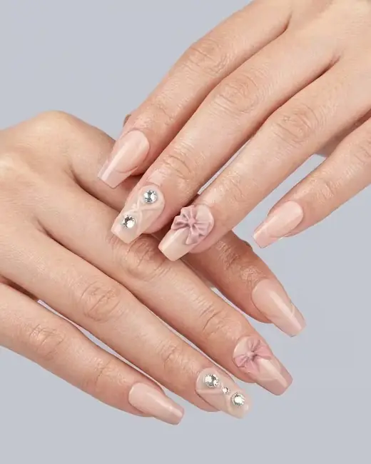 Hand wearing a nude press-on nail set from Artificial Nails